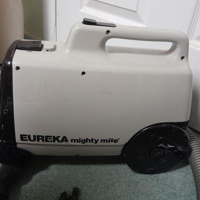 Eureka Mighty Mite canister Vacuum with attachment and extra bags and a cleaning bucket