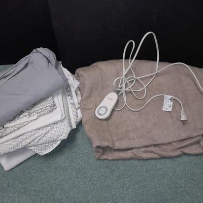 Two Queen sized sheet sets and a heated throw blanket
