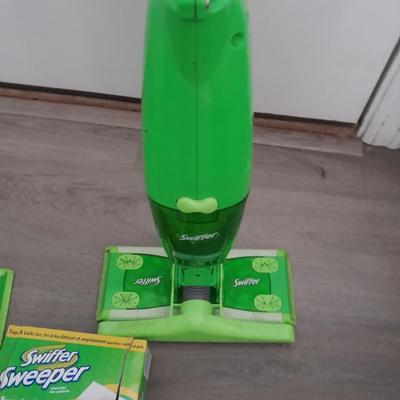 Two Swiffer mops and Swiffer pads