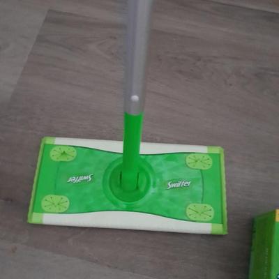Two Swiffer mops and Swiffer pads