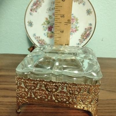 Filigree covered glass jewelry box, porcelain lidded heart dish, and decorative plate.