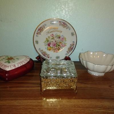 Filigree covered glass jewelry box, porcelain lidded heart dish, and decorative plate.