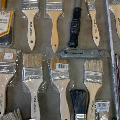 Painter's plastic and SO MANY paint / stain brushes!