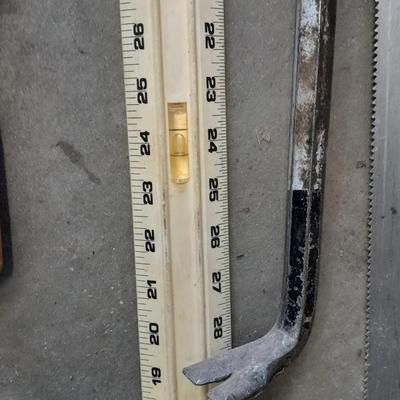Two clamps, hand saw, claw bar, and a large ruler