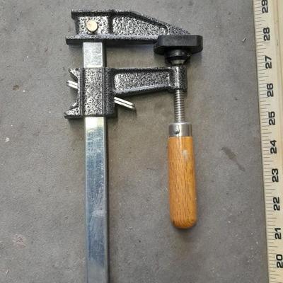 Two clamps, hand saw, claw bar, and a large ruler