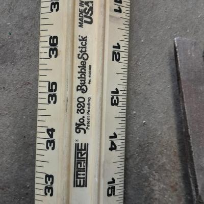 Two clamps, hand saw, claw bar, and a large ruler