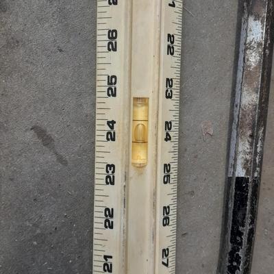 Two clamps, hand saw, claw bar, and a large ruler