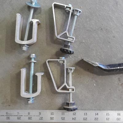 Bow saw, Claw bar, metal yard stick / ruler, and a tack hammer.