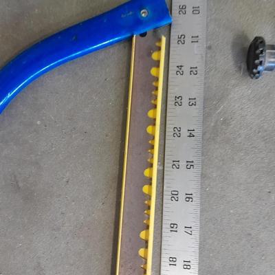 Bow saw, Claw bar, metal yard stick / ruler, and a tack hammer.