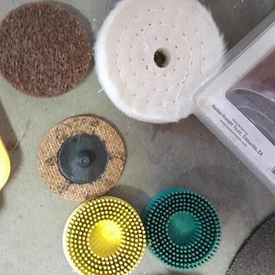 Assortment of wire and buffing wheels, sandpapers, and small tools