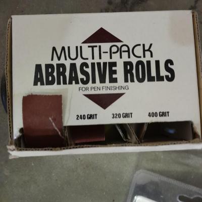 Assortment of wire and buffing wheels, sandpapers, and small tools