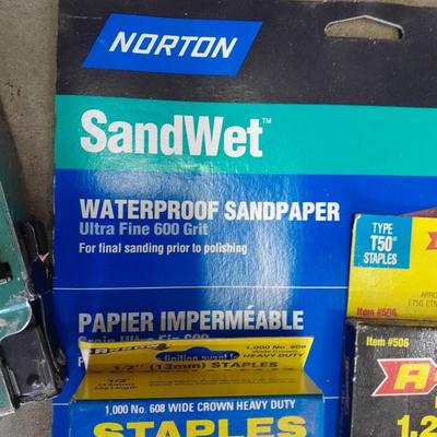Stapler, staples and sandpaper
