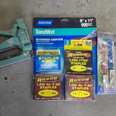 Stapler, staples and sandpaper