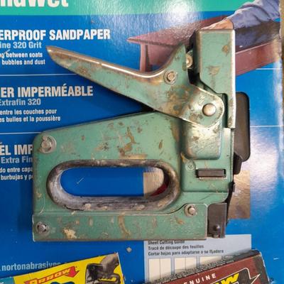 Stapler, staples and sandpaper