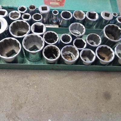 A bunch of different sockets and a torque wrench