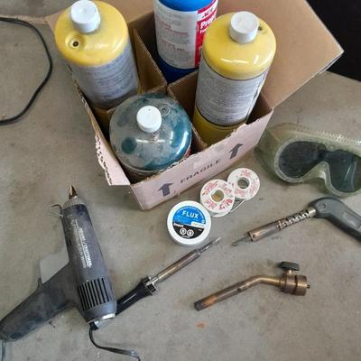 Propane torches, partially full bottles and a glue gun