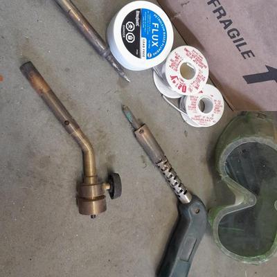 Propane torches, partially full bottles and a glue gun