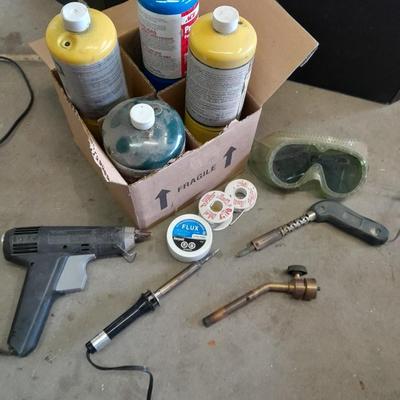 Propane torches, partially full bottles and a glue gun