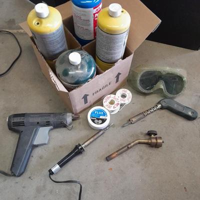 Propane torches, partially full bottles and a glue gun