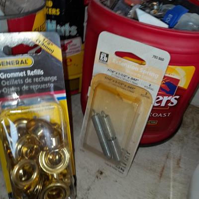 Packages, and cans full of home hardware - bolts, nuts, bins, and more