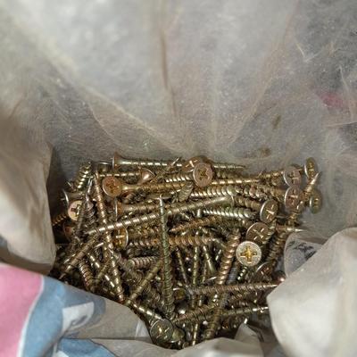 Packages, and cans full of home hardware - bolts, nuts, bins, and more