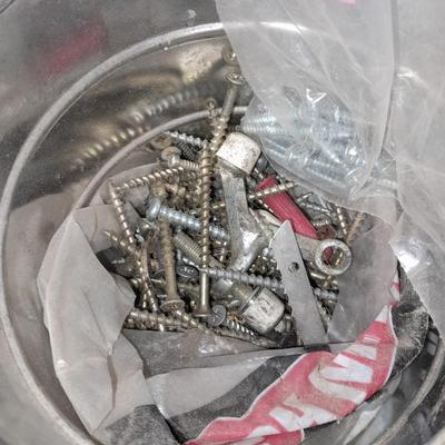 Packages, and cans full of home hardware - bolts, nuts, bins, and more