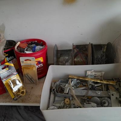 Packages, and cans full of home hardware - bolts, nuts, bins, and more