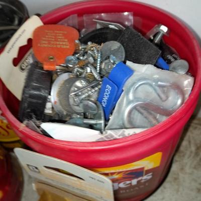 Packages, and cans full of home hardware - bolts, nuts, bins, and more