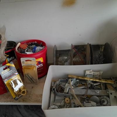 Packages, and cans full of home hardware - bolts, nuts, bins, and more