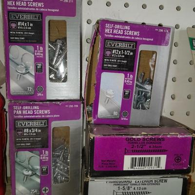 Boxes, and cans full of home hardware - bolts, nuts, nails, and more