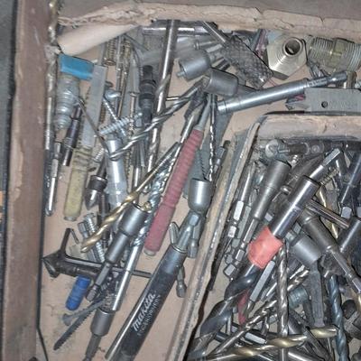 Assortment of drill accessories and empty tool cases