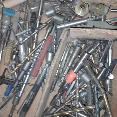 Assortment of drill accessories and empty tool cases