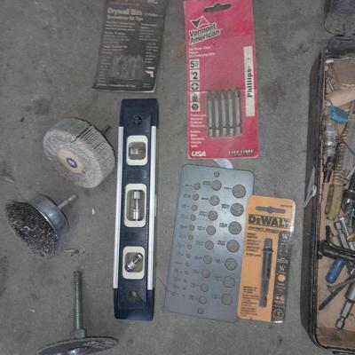Assortment of drill accessories and empty tool cases