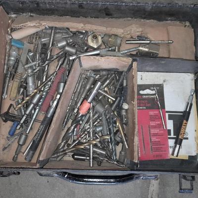Assortment of drill accessories and empty tool cases