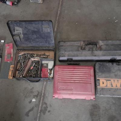 Assortment of drill accessories and empty tool cases