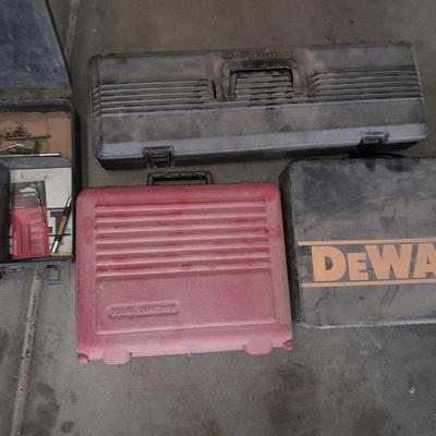 Assortment of drill accessories and empty tool cases