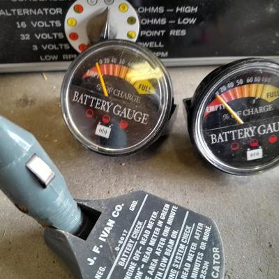 Assortment of gauges, a timing light, and a older battery charger