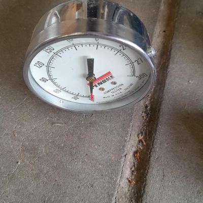 Assortment of gauges, a timing light, and a older battery charger