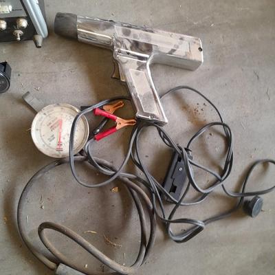 Assortment of gauges, a timing light, and a older battery charger