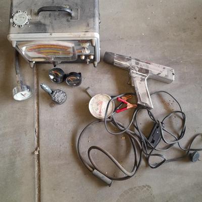 Assortment of gauges, a timing light, and a older battery charger