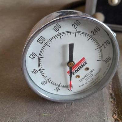 Assortment of gauges, a timing light, and a older battery charger
