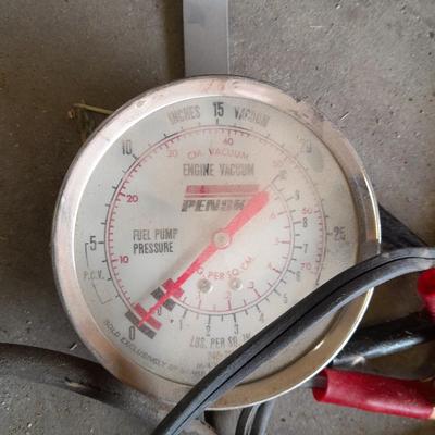 Assortment of gauges, a timing light, and a older battery charger