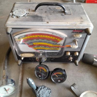 Assortment of gauges, a timing light, and a older battery charger