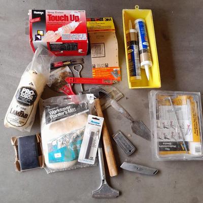 Assortment of painting and drywall tools and hardware