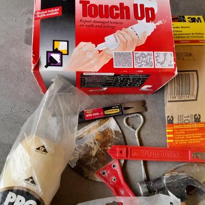 Assortment of painting and drywall tools and hardware
