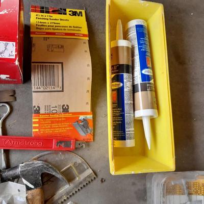 Assortment of painting and drywall tools and hardware