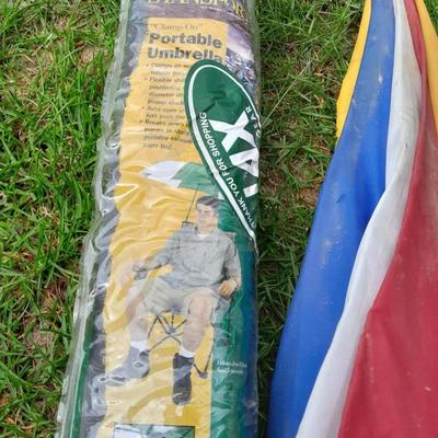 Two chair umbrellas, and a cloth tarp