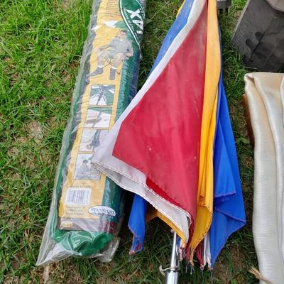 Two chair umbrellas, and a cloth tarp