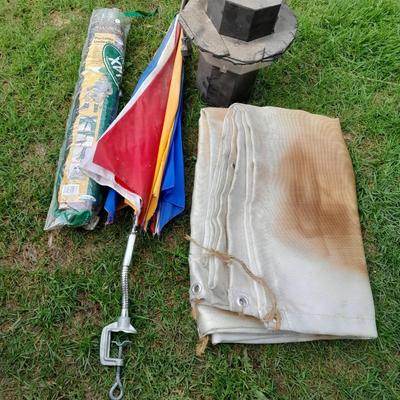 Two chair umbrellas, and a cloth tarp