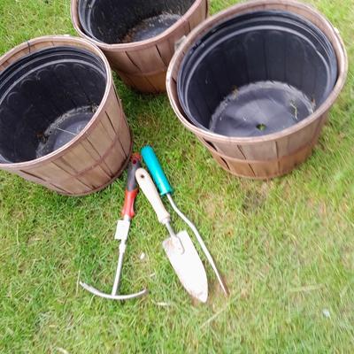 Three flowerpots a small hand shovel, weed puller and rake